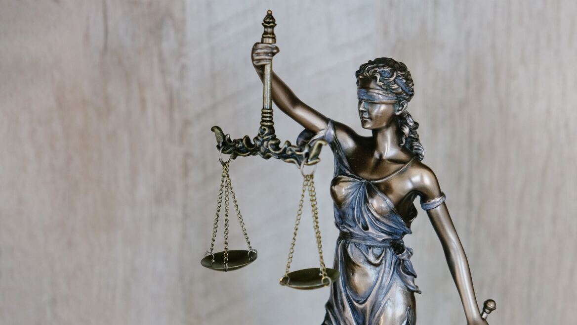 Lady Justice holding the scales of justice, representing the firm’s legal experience